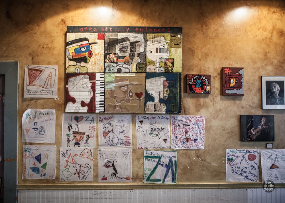 Customers’ drawings and paintings covering a dining room wall