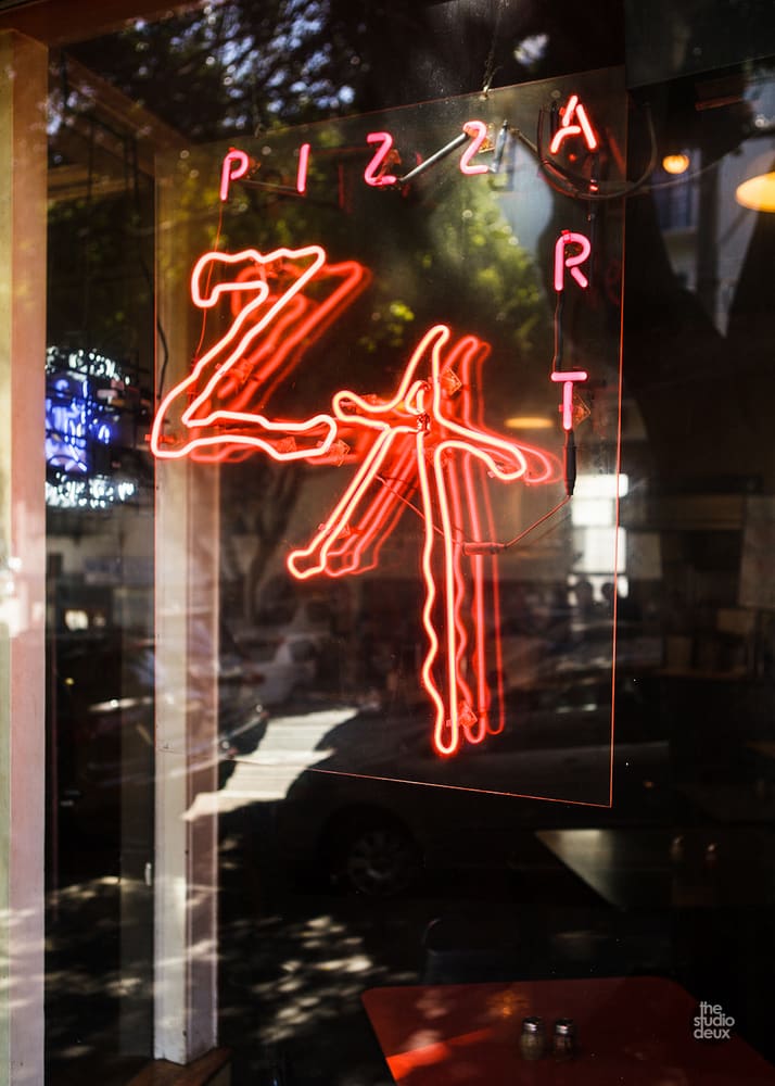The red ZA neon sign in the window