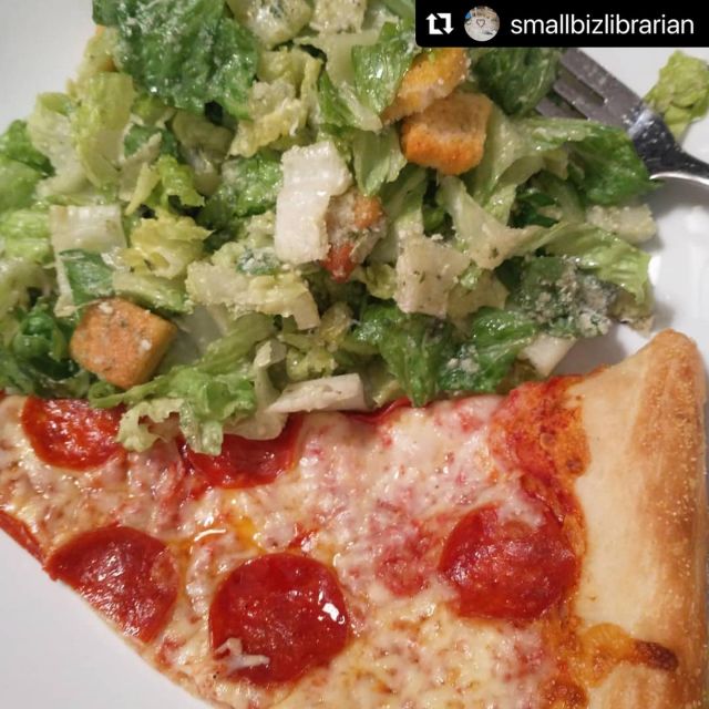 A pepperoni slice and a Caesar salad